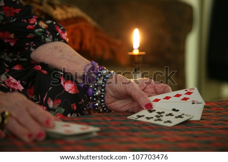 fortune teller\'s cards with candle light in back
