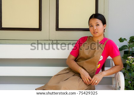 Young Thai woman distracted at the facade