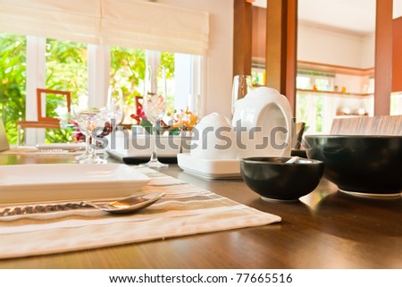 Set of kitchenware in wooden table in dining room