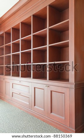 empty useful wooden shelves tilted out to left