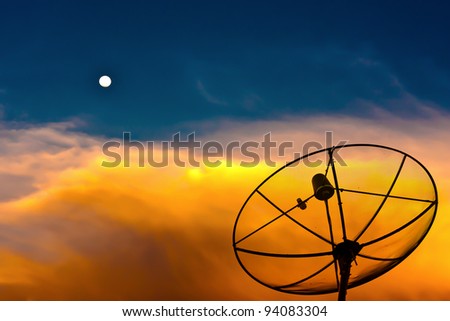 Parabolic satellite dish in twilight time with blue sky and moon
