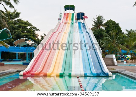 Lineal colorful striped water slider in the park
