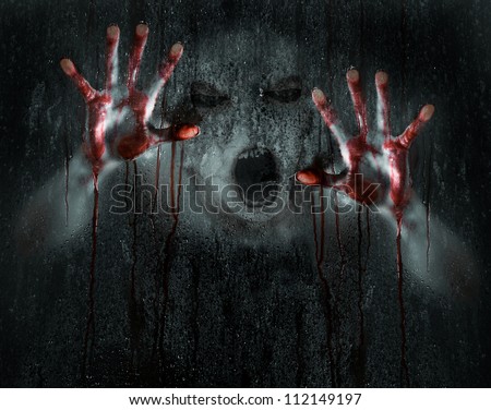 Dark Horror Scene of a Deformed Demon or Zombie with Bloody Hands against Wet Glass