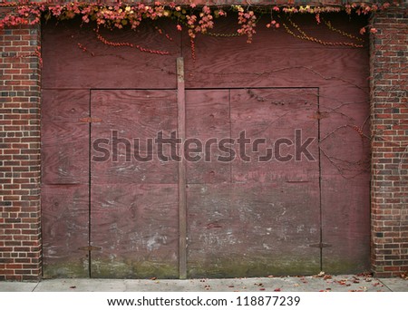  - stock-photo-old-red-wooden-doors-with-brick-wall-and-leaves-hanging-over-118877239