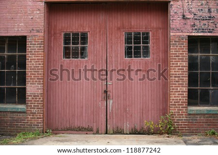 Old Red Wooden Industrial Doors with Industrial windows in Brick Walls