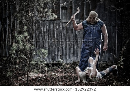 Horror scene of a woman crawling in the woods away from a hooded man with an Axe.