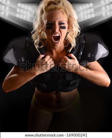 Sexy Fierce young woman Football Player with text space below