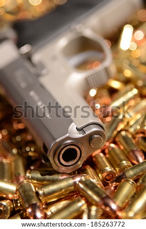 Pistol lying on brass bullets