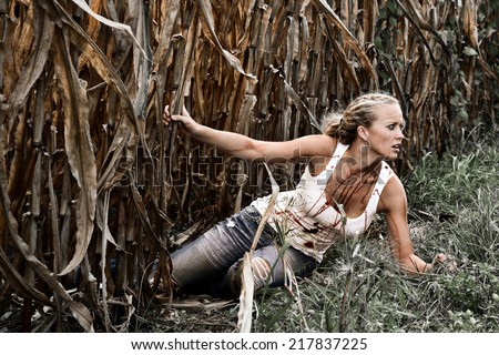 Horror Scene of a Pretty Blonde Woman falling in a Corn Field