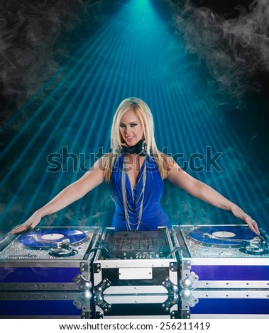 Beautiful DJ Girl Performing with Club Lights in the background