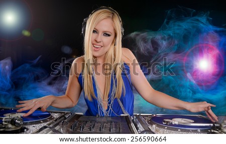 Beautiful DJ Girl Performing with Club Lights and smoke in the background