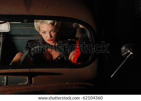 stock photo Pin Up Girl in a Classic Rat Rod Car