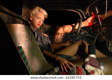 stock photo Pin Up Girl in a Classic Rat Rod Car