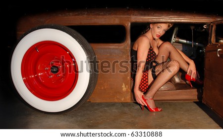 stock photo Pin Up Girl sitting in a Classic Rat Rod Car