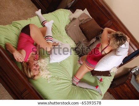 Two Young Women Having Fun (Pillow Fight)