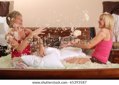 Two Young Women Having Fun (Pillow Fight)