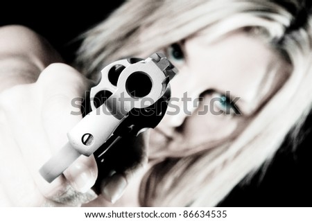 Sexy young woman pointing a gun Focus is on Gun