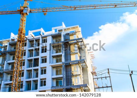 Apartments construction site with yellow crane