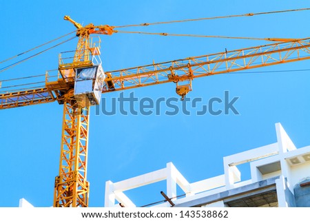 Apartments construction site with yellow crane