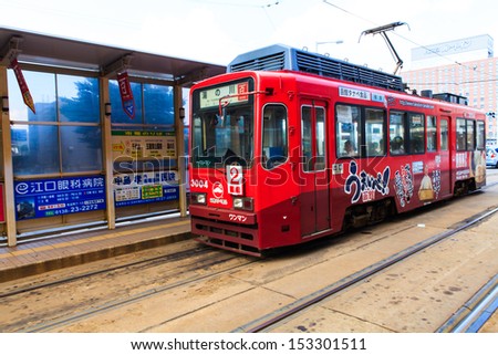 Hakodate, Japan - August 12, 2013 : Tram with tram station on the road in a summer day in hakodate , august 12 2013, japan