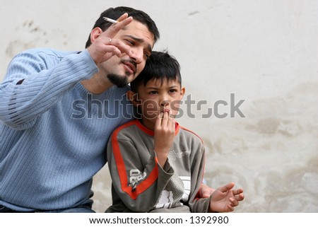 father pointing with finger at talking with his son