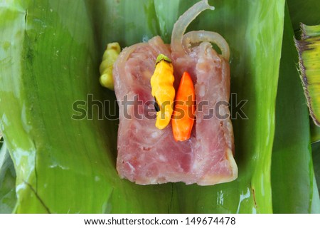 pork, shredded and salted, bound tightly with banana leaves, and eaten slightly fermented