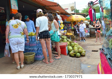 KA LAN, CAMBODIA - NOVEMBER 24 : Tourists are buying food and drink at local market on November 24, 2013 in Ka Lan, Cambodia.