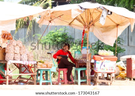 KA LAN, CAMBODIA - NOVEMBER 23 : Unidentified Khmer woman is selling foods at local market on November 23, 2013 in Ka Lan, Cambodia.