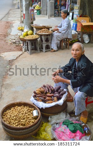 HUE, VIETNAM - MARCH 15 : Merchants are selling foods and fruits at Thien Mu temple  footpath market stall on March 15, 2014 in Hue, Vietnam.
