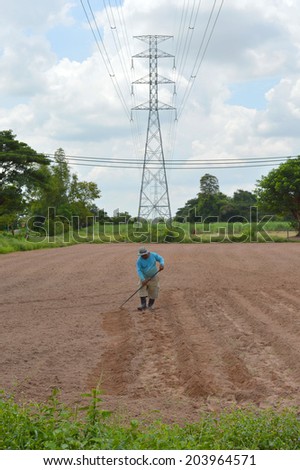 MAHASARAKHAM - JULY 8 : Farmer is preparing soil to grow straw mushrooms at Lhao Noi village on July 8, 2014 in Mahasarakham, Thailand.