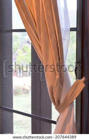 brown curtain cloth at house window