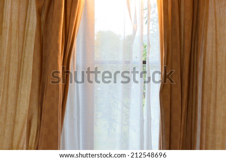 brown curtain cloth at house window