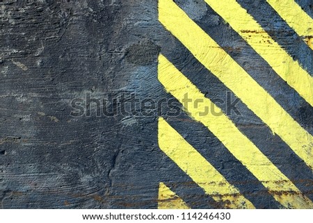 Black wall with yellow paint to draw attention background