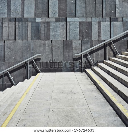 geometric modern wall with stairs leading up. square background