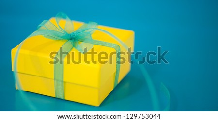 Yellow Gift Box on a Blue Background