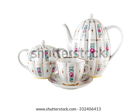 Porcelain teapot, teacup with saucer and sugar-bowl with floral roses ornament in retro style isolated over white background