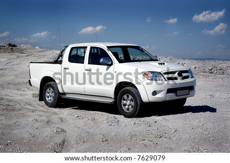 Pickup truck on light sand