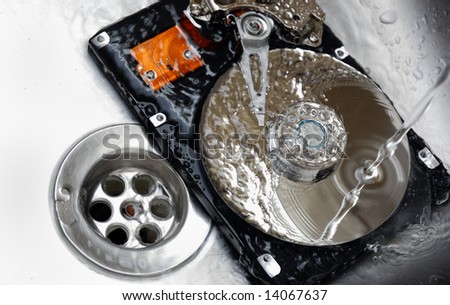 Hard Drive under tap water. Concept of Cleaning your Hard Drive.