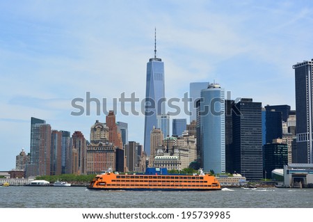NEW YORK CITY, USA - May 26, 2014: Staten Island Ferry cruising in New York Harbor with the Lower Manhattan skyline in the background.