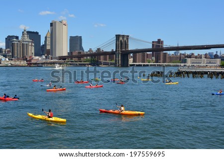 NEW YORK CITY, USA - June 6, 2014: People kayaking on the East River with the Brooklyn Bridge in the background.
