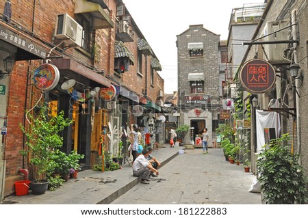 TIANZIFANG, SHANGHAI - JUNE 25: People in Tianzifang on June 25, 2013. Tianzifang is an arts and crafts enclave that has developed from a renovated residential area in the French Concession area of Shanghai.