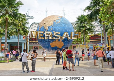 SINGAPORE - JANUARY 5 : Tourists and theme park visitors taking pictures of the large rotating globe fountain in front of Universal Studios on January 5, 2015 in Sentosa island, Singapore.