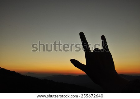 Love hand sign in the evening.