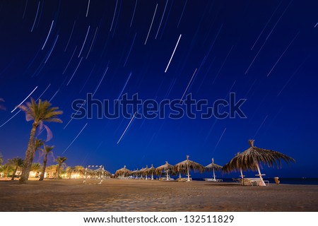 Star trails on a deserted tropical beach at night