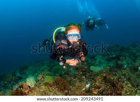 A female SCUBA diver on a tropical coral reef