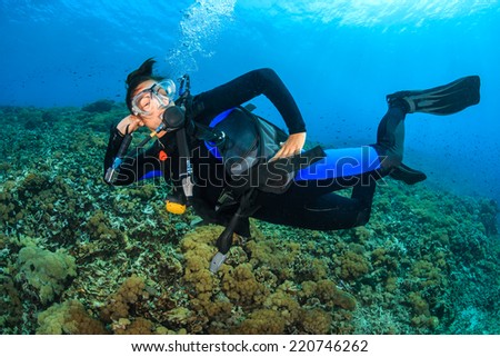 Female SCUBA diver posing underwater