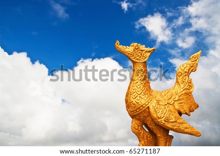 traditional thai sculpture bird on cloud blue sky