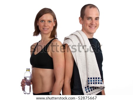 Young, caucasian fitness couple posing after a hard workout, smiling at camera