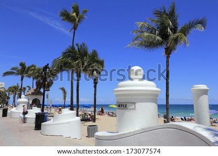 FORT LAUDERDALE, FLORIDA - APRIL 8, 2013: Many people relaxing, suntanning enjoying spring break at the popular tropical public beach on a warm and sunny day near Cortez Street and State Road A1A.