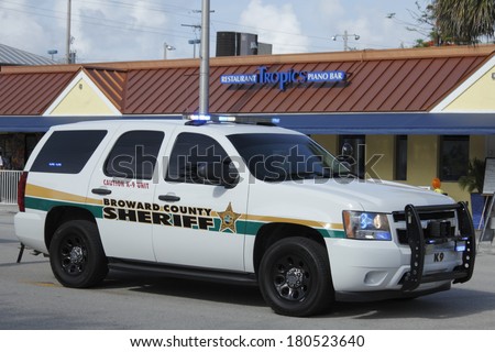WILTON MANORS, FLORIDA - JUNE 23, 2013: Large white Broward County Sheriff K-9 truck with its lights on parked at entrance to second day of Stonewall Summer Pride on Wilton Drive at NE 20th Street.